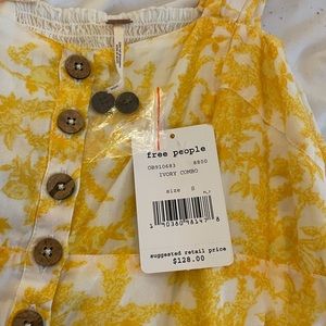 Pretty yellow Free People dress, tags still on. Was once $128, selling for $45.